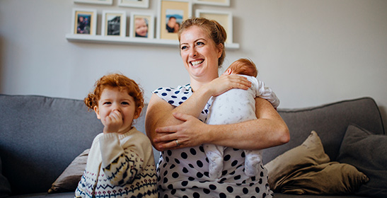 woman smiling holding baby