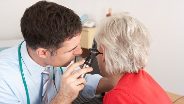 Doctor examining ear of patient