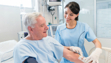 patient on IV cancer treatment drip with nurse administering