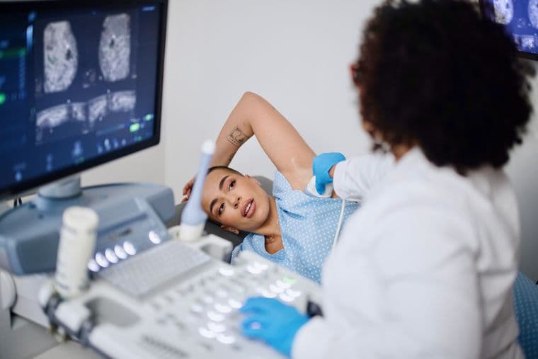 A nurse examining a female patient