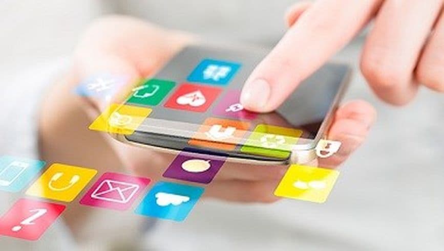 Finger using smartphone with various icons and graphics overlaid