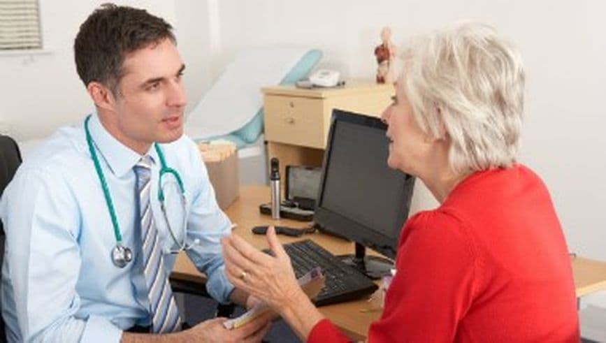 Older female in consultation with male GP