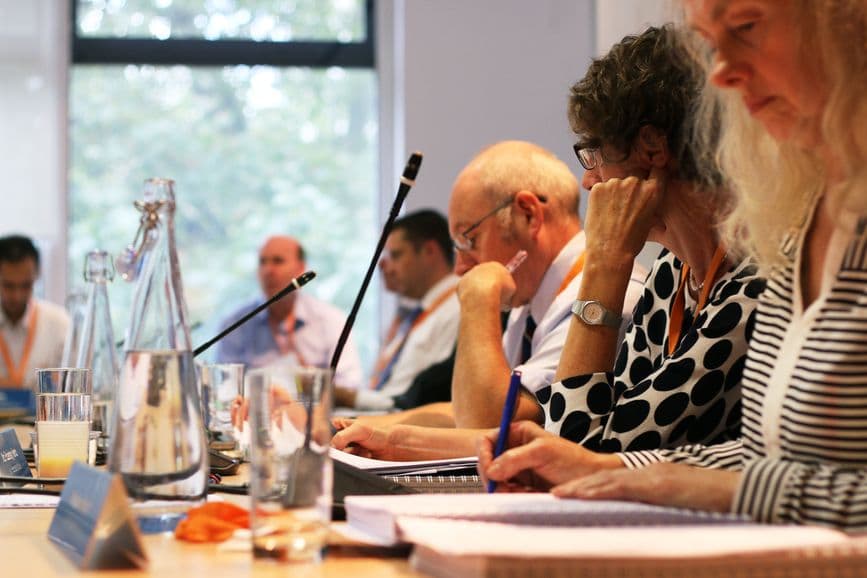 Committee members, sat around a table