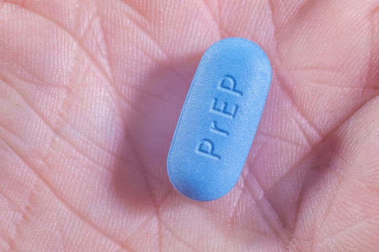A person holding a PrEP tablet