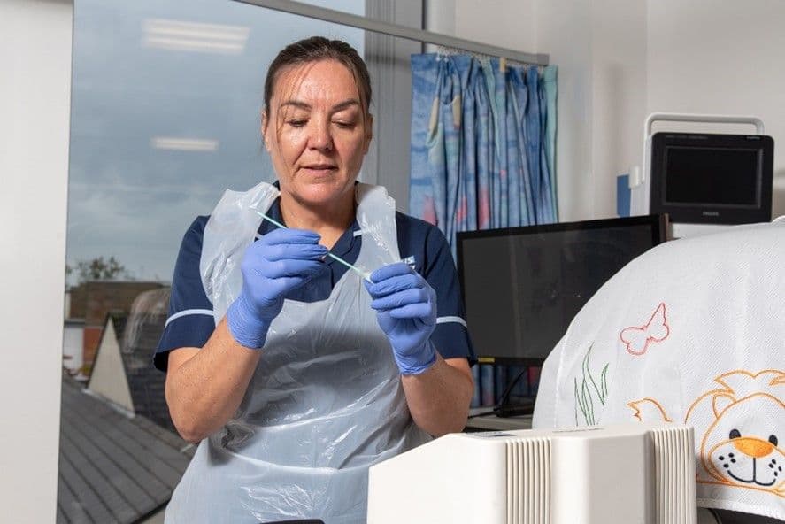 Nurse at Manchester University NHS Foundation Trust using the Genedrive device